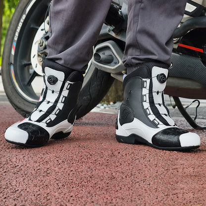 Person wearing black and white motorcycle boots on a motorcycle.